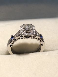 a diamond and blue sapphire ring on display