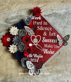 a red graduation cap with flowers and butterflies on it that says work hard in science & let success make the noise