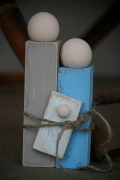 two eggs are placed on top of each other in a wooden block with twine