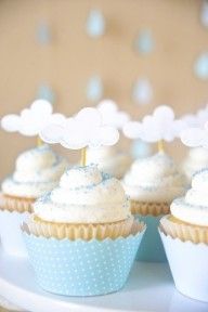 cupcakes with white frosting and blue decorations