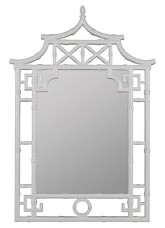 a white mirror that is on top of a table and has an ornate frame around it