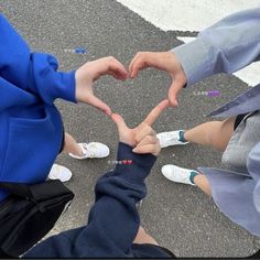 three people making a heart with their hands