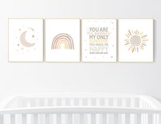 three nursery prints with rainbows, stars and moon in pastel colors on a white wall