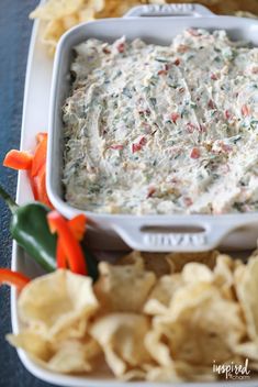 a white tray filled with chips and dip