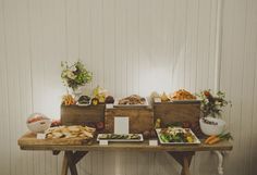 a wooden table topped with lots of food