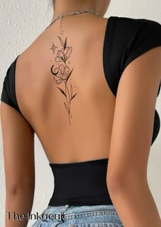 a woman's back tattoo with flowers on it