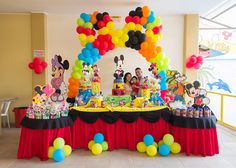 a mickey mouse themed birthday party with balloons