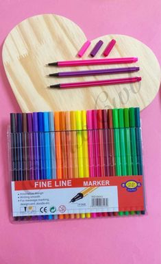 the wooden heart is filled with colored pencils and markers for making valentine's day cards