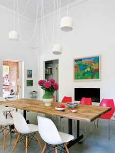 a dining room table with white chairs around it