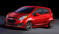 a red chevrolet spark car is shown in this artistic rendering, it appears to be an electric vehicle