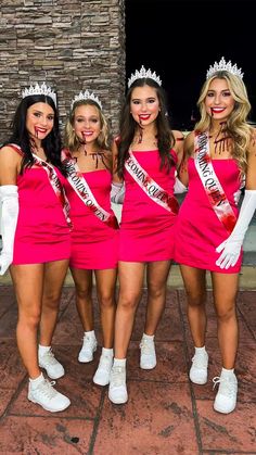 three beautiful women in pink dresses and crowns posing for the camera with one woman wearing a tiara