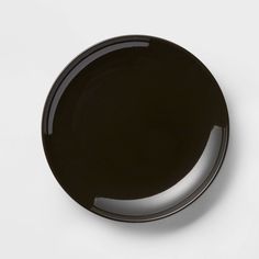 a black plate sitting on top of a white table