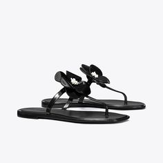 A sculpted bloom embellishes a classic flip-flop sandal with a playful focal point. The jelly outsole is perfect for the beach or to wear poolside. Flower Jelly, Jelly Flower, Christmas Guide, Flower Sandals, Beach Slides, Tory Burch Sandals, Jelly Sandals, Footwear Design Women, Designer Sandals