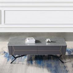 a grey coffee table sitting on top of a rug