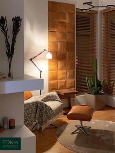 a living room filled with furniture next to a window covered in wooden blinds and plants