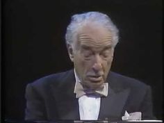 an older man wearing a tuxedo and bow tie in front of a black background