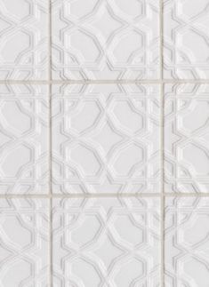 a white tiled wall with squares and lines