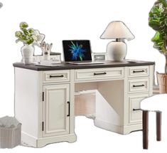 a white desk topped with a laptop computer next to a potted plant and lamp