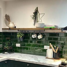 the kitchen counter is covered with pots and pans on it's shelf above the sink