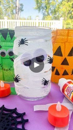 halloween mason jar craft for kids using plastic cups and candy tubes with faces on them