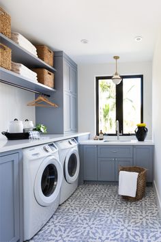 the laundry room is clean and ready to be used as a washer and dryer