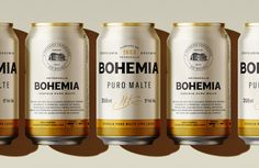 four cans of bohemia beer are lined up