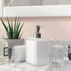 a bathroom sink with soap dispenser, toothbrush holder and toiletries