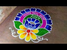 the happy new year logo is painted on the ground with colorful flowers and green leaves