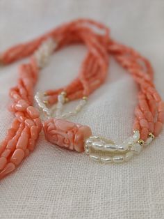 This mid-century multi-strand necklace is a beautiful combination of natural coral and Kashi (river) pearls. The five-strand necklace contrasts the pink coral with luminescent river pearls and 14k yellow gold beads. The long 32-inch length easily slips on for a seamless design. A large, carved coral bead with an Asian motif is the finishing touch of this special necklace. * 32-inch length * 5 strands * Coral and Kashi (river) pearl beads * 14k gold accent beads Thank you for visiting Second Chap Elegant Hand-strung Coral Necklaces, Elegant Hand-strung Coral Necklace, Elegant Coral Hand-strung Necklaces, Elegant Double Strand Coral Necklace, Multi-strand Red Coral Beaded Necklaces, Coral Multi-strand Beaded Necklaces, Coral Multi-strand Beaded Necklace, Multi-strand Coral Beaded Necklace For Gift, Coral Multi-strand Beaded Necklace For Gift