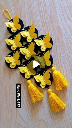 a video showing how to make paper butterflies with yellow tassels and black background