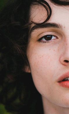 a woman with freckled hair and blue eyes