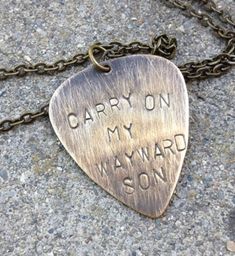 "Carry on my wayward son" has been handstamped on a guitar pick-shaped or round silver stamping blank. The chain is approx 18". Whether you're a fan of Supernatural, or just a lover of good music, this song is awesome and this necklace is clever. [Note: These necklaces are made as they're ordered, so they may vary a tiny bit from the listed photos (such as in the placement of handstamped letters, or type of chain)] Please note: If you order silver, it's a non-distressed, silver tag: only the bro Adjustable Hand Stamped Necklaces For Father's Day, Son Necklace, Geek Jewelry, Wayward Son, Silver Pieces, Guitar Pick, Cute Gifts, Hand Stamped, Good Music