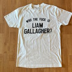 Brand New And Unworn But Without A Tag. The First Photo Is From The Manufacturer. The Resto Of The Photos Are Mine (Sorry For Creases!). Measurements Are On The Last Two Photos. White Band Merch Top With Funny Text, White Tops With Funny Text For Fans, Oasis Tshirt, Liam Gallagher, First Photo, White T, White Tshirt, Next Level, New Color