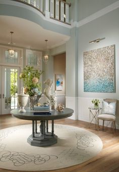 a living room filled with furniture and flowers in vases on top of a table