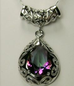 Mystic Topaz Pendant Necklace, Victorian Jewelry P28 This is a stunning Victorian inspired pendant necklace. This beautiful necklace is handcrafted from sterling silver. The flawless 6 carat man-made Mystic Topaz is a pear cut gemstone. Notice the beautiful craftsmanship of the silver filigree design. The teardrop shape setting outlines the lovely stone. The matching bail enhances the entire look. This necklace grabs attention with its simple beauty. Silver Teardrop Necklace With Jewels, Silver Teardrop Jeweled Necklace, Silver Briolette Gemstone Drop Necklace, Silver Drop Necklace With Gemstone Accents, Silver Drop Necklace With Jewels, Pear Shape Pendant, Pear Shaped Pendant, Topaz Pendant, Filigree Design