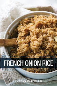 french onion rice in a white bowl with a wooden spoon and napkin next to it