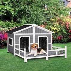 a dog is sitting in its kennel on the grass