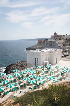 many umbrellas are set up on the beach