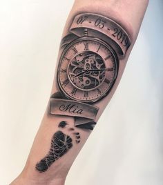 a man's arm with a clock and footprints tattoo on the left side of his arm