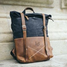 "Crisp lines of the unisex Thames combine in a stylish backpack. It's a bold heritage design at home on the high street, high-fashion, or the highlands. Adjustable leather straps, magnetic clasps, and full width zipped closure, keep this fold top rucksack sleek and secure. But its deep compartmented interior is still large-laptop capable. A robust and versatile travel companion, the Thames fits in with the most elegant of company. Our signature unisex range features a treated leather finish, perfect for the daily commute around the city, or a weekend adventure in the country. Details: - Capacity: 16L - Dimensions: H50cm x W36cm x D10cm - Weight: 1kg - Reclaimed leather - Waxed heavy 18oz cotton and double lining - 1 interior pocket - Fits up to a 17\" laptop - Unique fold top fastening sys Rectangular Waxed Leather Backpack For Outdoor, Rectangular Leather Backpack With Waxed Finish For Outdoor, Black Canvas Bag With Leather Patch, Black Leather Backpack With Canvas Lining, Everyday Black Waxed Canvas Backpack, Black Waxed Canvas Backpack For Everyday Use, Black Waxed Canvas Standard Backpack, Black Waxed Finish Backpack For Travel, Rectangular Waxed Finish Backpack For Outdoor