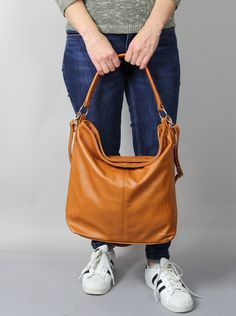 The leather handbag is made of 100% high quality natural Italian leather. Leather hobo bag in fashionable and classical style. The interior of the bag has lining. The shopper purse is very roomy. Fits easily A4 format (US Lettel format) Large pocket inside of the bag divides the compartment into two parts Closed with a zipper / slider It has as a long attachable and adjustable strap allowing you to wear is on the shoulder or crossbody. Inside there are two pockets: one zipped, one for a phone an Cognac Hobo Bag With Smooth Grain For Everyday, Daily Use Cognac Hobo Bag With Smooth Grain, Everyday Brown Leather Hobo Bag, Brown Hobo Bag With Removable Pouch For Daily Use, Brown Hobo Bag With Removable Pouch For Everyday, Everyday Brown Hobo Bag With Adjustable Strap, Brown Smooth Grain Hobo Bag For On-the-go, Cognac Satchel Shoulder Bag For Everyday Use, Cognac Satchel Shoulder Bag