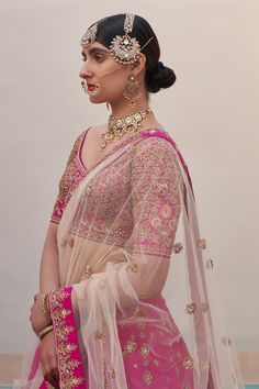 Rani pink lehenga with traditional zardozi technique using silken threads, dabka, cutdana and sequins work. Paired with blouse, cream dupatta and pink dupatta.
Component: 4
Pattern: Embroidery
Type Of Work: Zardozi, silk thread, dabka, cutdana, sequin
Neckline: Leaf neck
Sleeve Type: Half
Fabric: Raw Silk
Color: Pink
Other Details: 
Scallop border
Side and back tassel tie-up
Sheer embroidered dupatta
Note: Necklace and hair accessory worn by the model is not for sale
Occasion: Bride - Aza Fashio Pink Chandbali Choli With Intricate Embroidery, Pink Dola Silk Chandbali Lehenga, Pink Dori Work Chandbali Saree, Pink Saree With Dori Work For Reception, Pink Kundan Dupatta With Intricate Embroidery, Pink Kundan Traditional Wear For Reception, Pink Kundan Saree, Traditional Pink Saree For Reception, Bollywood Style Pink Traditional Wear With Kundan