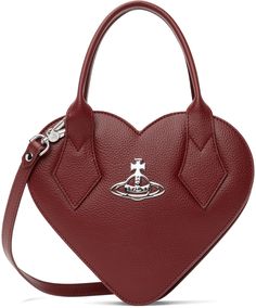 Heart-shaped grained faux-leather top handle bag in red. · Rolled carry handles · Adjustable and detachable crossbody strap · Logo hardware at face · Two-way zip closure · Card slot at interior · Twill lining · H7.5 x W9 x D2.75 Supplier color: Red Vivienne Westwood Heart Bag, Heart Shape Bag, Heart Shaped Purse, Heart Crossbody Bag, Vivienne Westwood Bags, Vivienne Westwood Red, Heart Shaped Bag, Red Leather Bag, Faux Leather Top