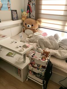 a teddy bear sitting on top of a bed next to a desk