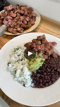 two plates with meat, rice and beans on them