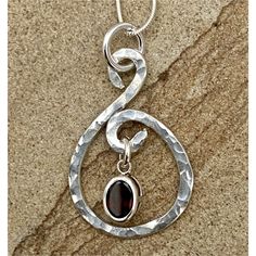 Looking to radiate confidence and sunlight in handcrafted artisan jewelry? You’re in luck — this piece features a 6x8mm pyrope garnet in a delicate but powerful pendant that truly catches the light. Centered in hammered sterling silver, this piece is impossible to look away from! sterling pendant, 1.25"x.88", 6x8mm pyrope garnet 18" sterling chain adjustable leather cord (18"-20") Rocks Jewelry, Wire Wrapping Beads, Silversmithing Jewelry, Pyrope Garnet, Radiate Confidence, Rock Jewelry, Silver Jewelry Design, Diy Wire Jewelry, Sterling Pendant