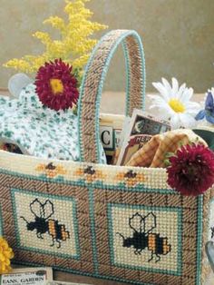 a basket filled with flowers and books on top of a wooden table next to other items