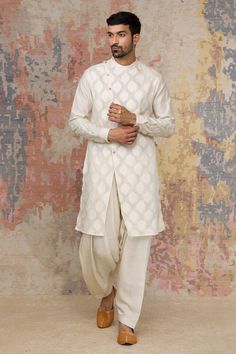 Ivory overlap kurta with woven motifs, asymmetric button placket and floral embroidered sleeves. Paired with salwar.
Component: 2
Neckline: Mandarin
Sleeve Length: Full
Fabric: Woven Chanderi, Cotton Silk Satin
Color: White
Embroidered sleeves
Resham work - Aza Fashions Kurta Set For Men, Resham Work, White Kurta, Blouse Measurement, Embroidered Sleeves, Lehenga Blouse, Satin Color, Indian Designer Wear, Kurta Set