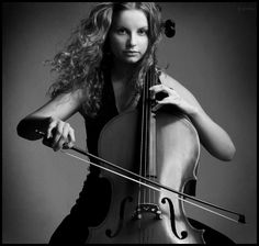 a woman with long hair holding a violin