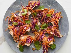 a plate filled with lots of veggies on top of a marble countertop